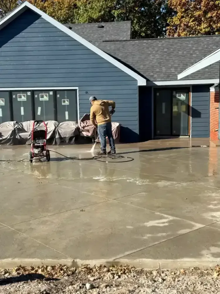 Freshly poured patio slab with expansion joints in a Independence backyard