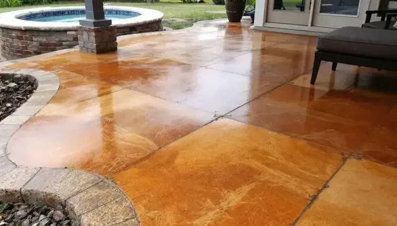 Amber-toned acid stain on a stamped concrete patio in Lenexa