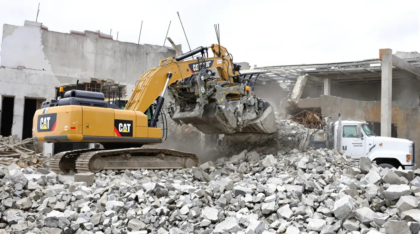 Concrete slab demolition with hydraulic breaker on a Kansas City redevelopment site